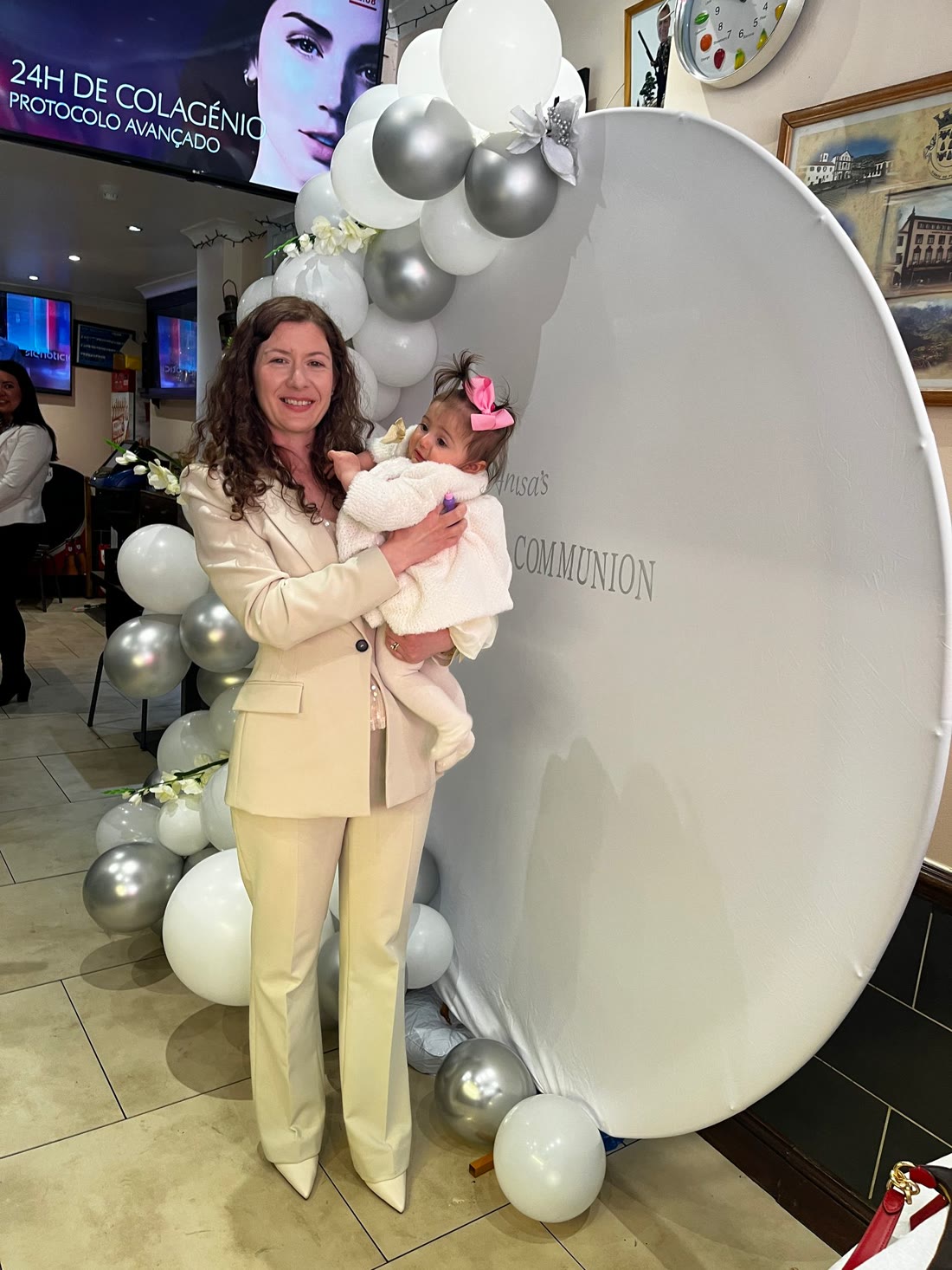 Communion celebration — round backdrop with balloon garland & name display