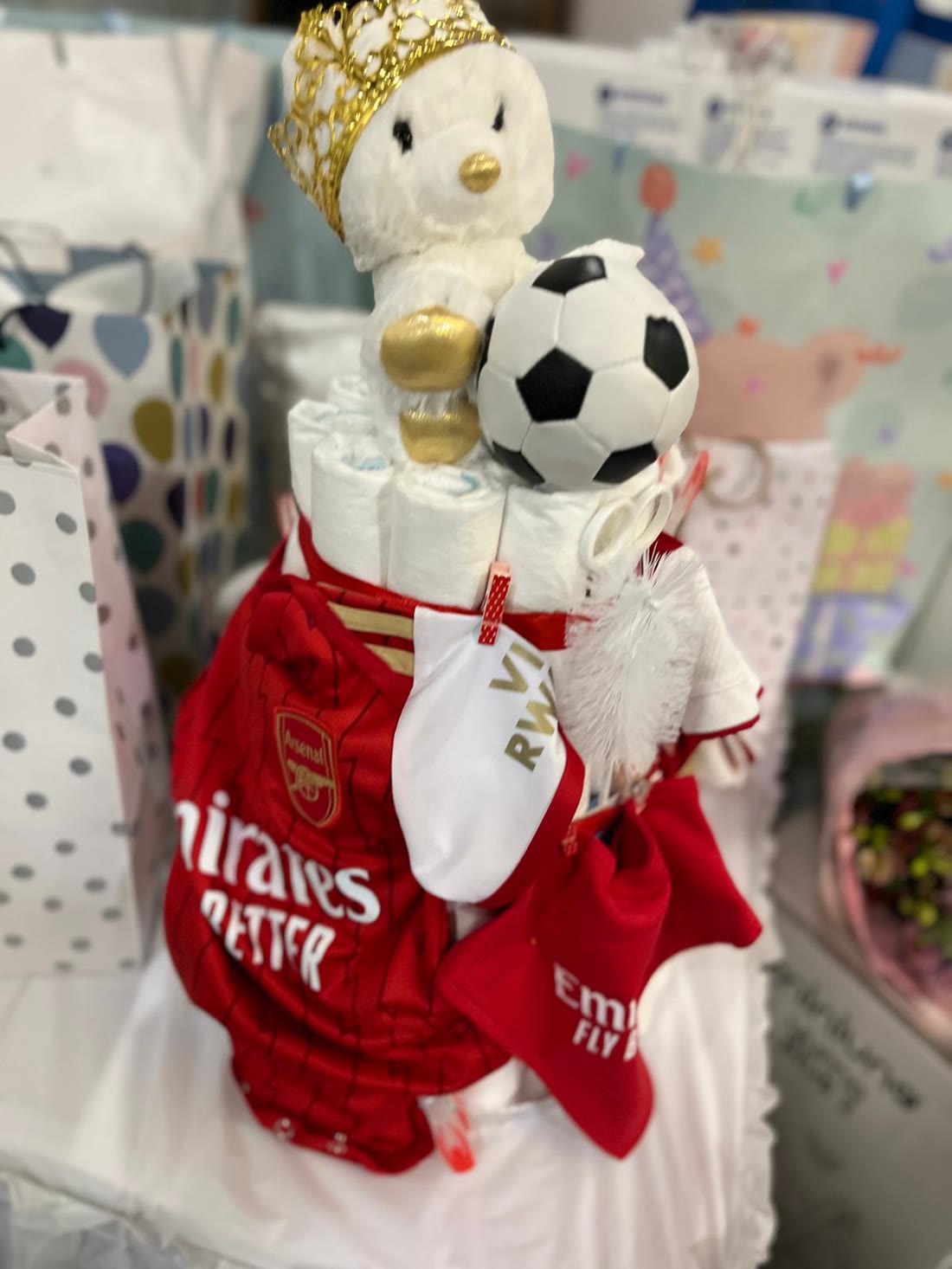 Baby shower nappy cake styled in a football kit with gifts & favours